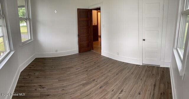 unfurnished bedroom featuring dark wood-type flooring