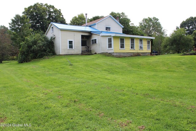 back of property featuring a yard