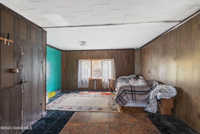 unfurnished bedroom with wooden walls