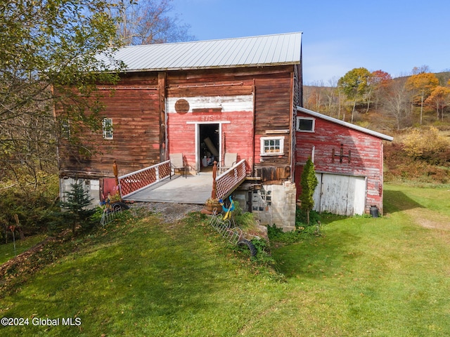 rear view of property with a yard