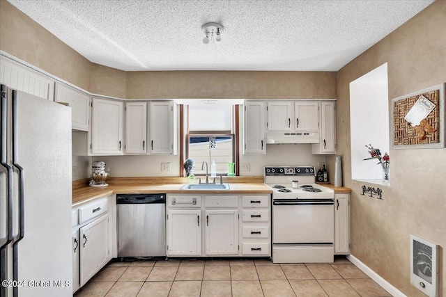 kitchen featuring sink, white cabinetry, and white appliances