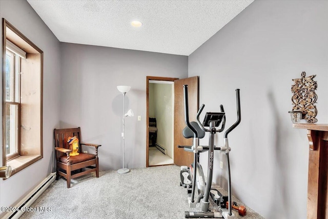 workout room with a baseboard radiator, a textured ceiling, and carpet floors