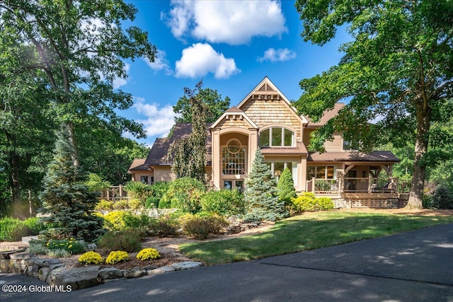 view of front of house with covered porch and a front yard