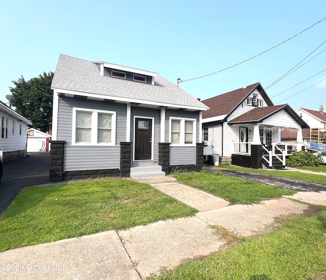 bungalow with a front yard