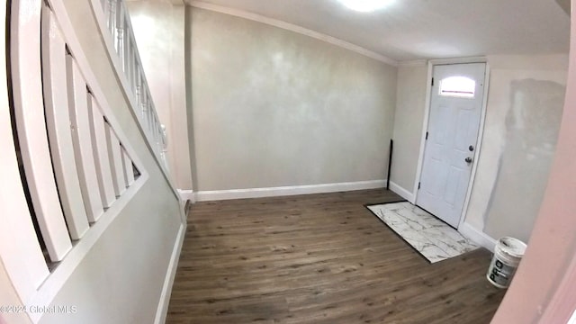 entryway with ornamental molding and dark hardwood / wood-style floors