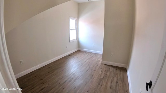 additional living space with lofted ceiling and light wood-type flooring