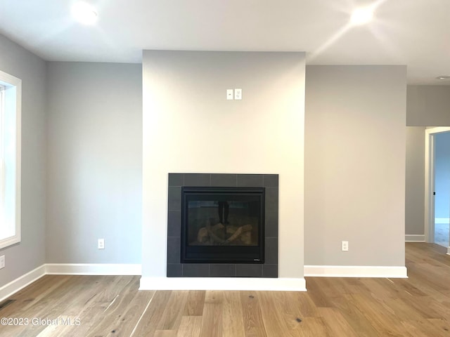 interior details featuring hardwood / wood-style floors and a fireplace