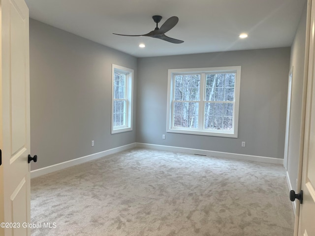 carpeted empty room featuring ceiling fan