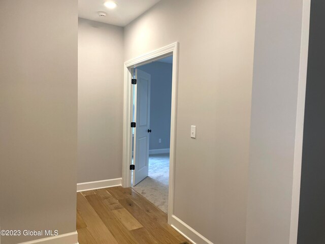 hall with light colored carpet