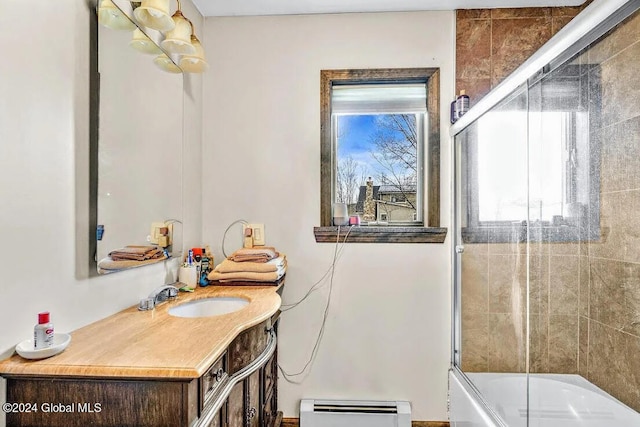 bathroom with a baseboard radiator, bath / shower combo with glass door, and vanity