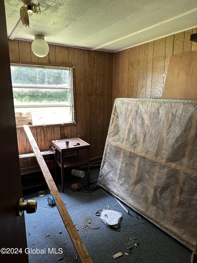 bedroom with wood walls