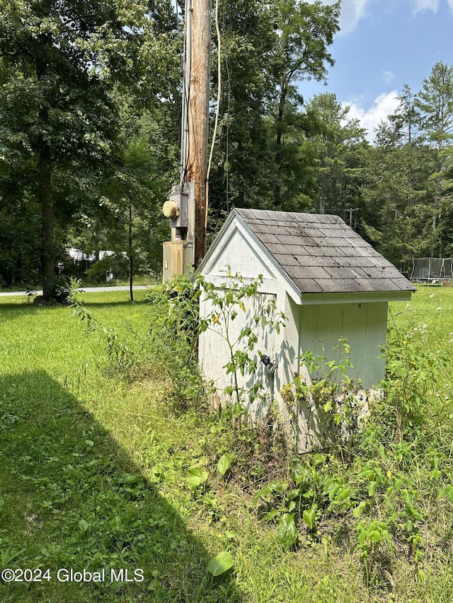 view of outbuilding with a lawn