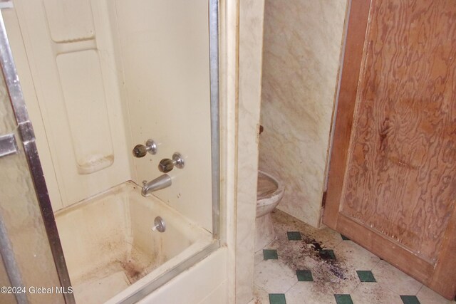 bathroom featuring  shower combination, toilet, and tile patterned flooring