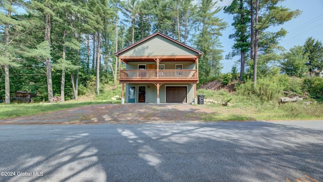 raised beach house featuring a garage