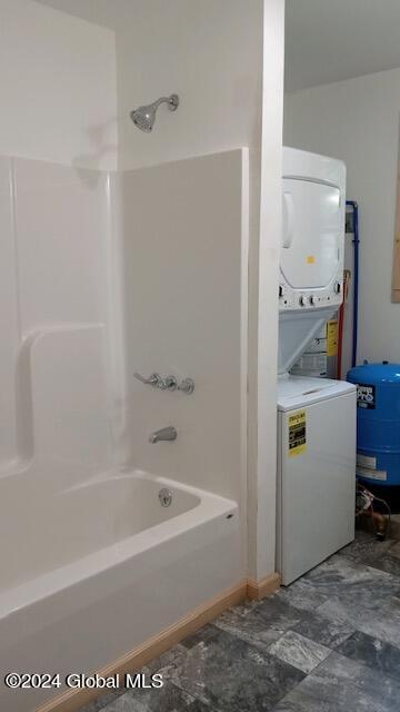 bathroom with  shower combination and stacked washer and clothes dryer