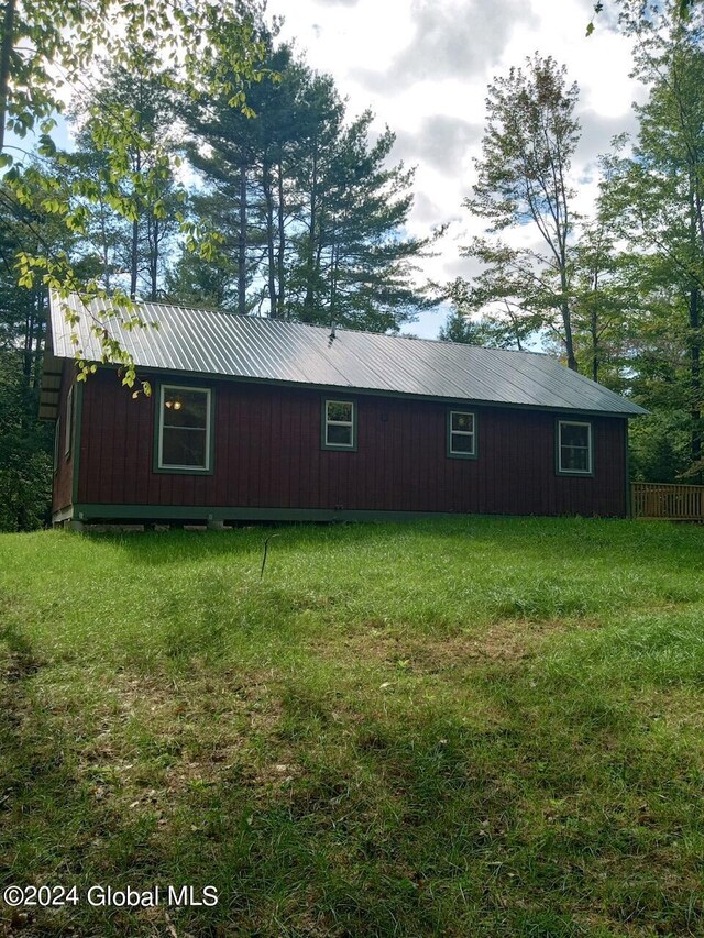 view of side of home featuring a lawn