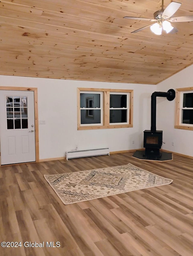 unfurnished living room featuring a wood stove, wooden ceiling, vaulted ceiling, hardwood / wood-style flooring, and baseboard heating