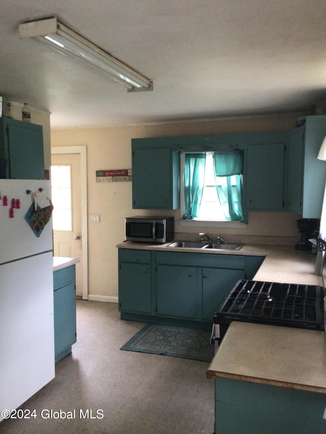 kitchen featuring sink and white refrigerator