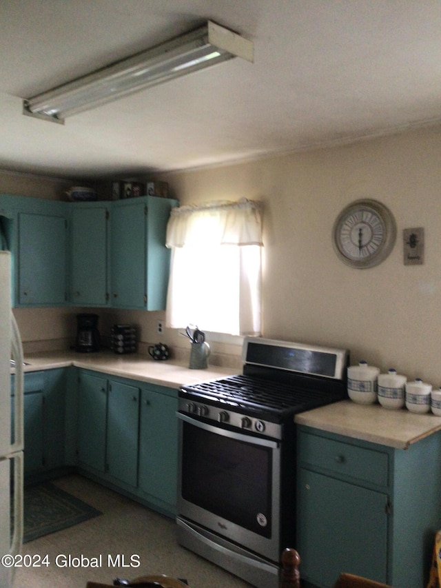 kitchen with stainless steel range with gas cooktop and white fridge