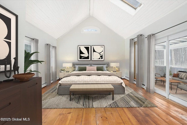 bedroom featuring high vaulted ceiling, hardwood / wood-style flooring, access to outside, a baseboard heating unit, and a skylight