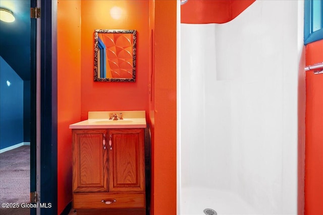 bathroom featuring vanity and a shower stall