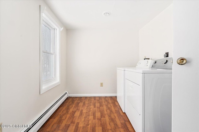 laundry room with wood finished floors, baseboards, laundry area, independent washer and dryer, and baseboard heating