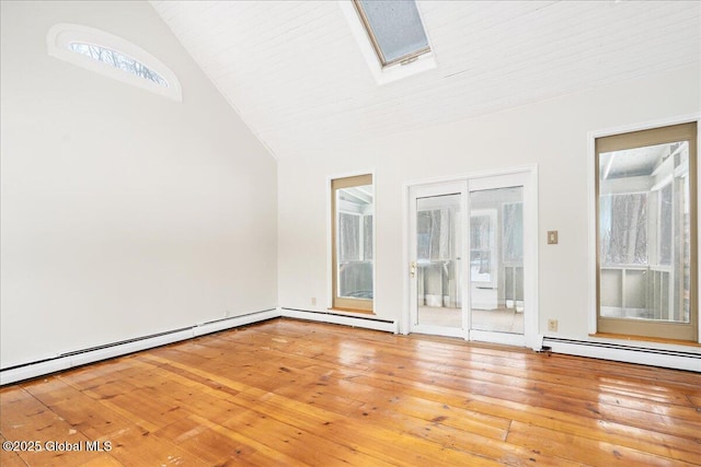 unfurnished room featuring lofted ceiling with skylight, a baseboard heating unit, and hardwood / wood-style floors