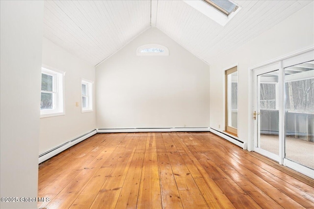 unfurnished room featuring a baseboard radiator, vaulted ceiling with skylight, and light wood-style floors