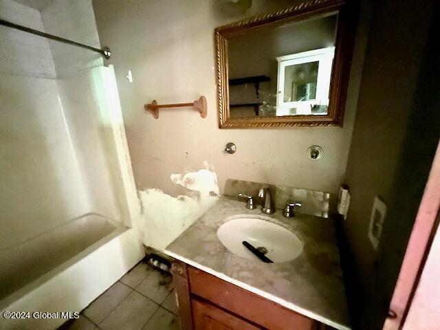 bathroom featuring tile patterned flooring, vanity, and shower / bathing tub combination