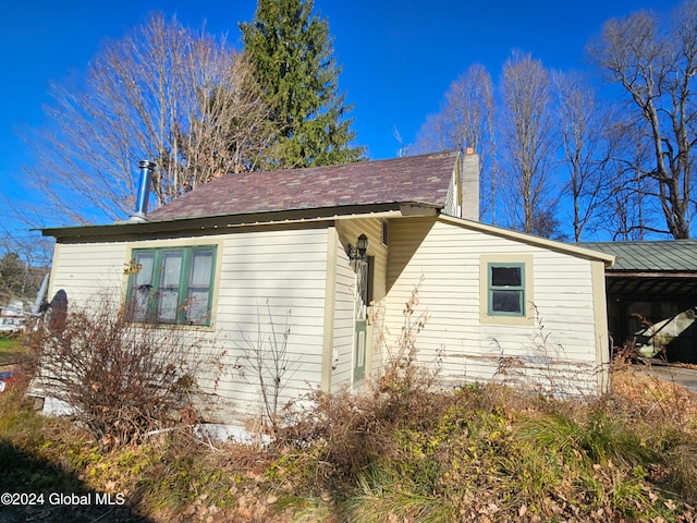 view of property exterior featuring a carport