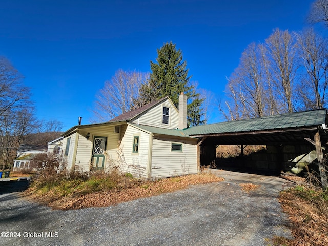 view of home's exterior with a carport