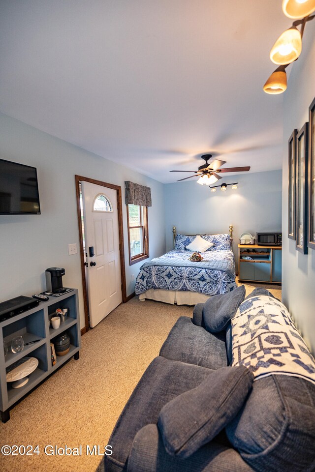 bedroom with ceiling fan and carpet floors