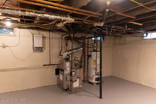 basement featuring gas water heater and heating unit