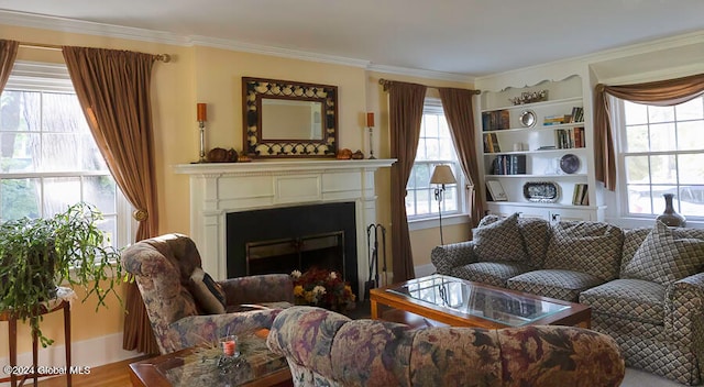 living room featuring a healthy amount of sunlight, crown molding, and hardwood / wood-style flooring