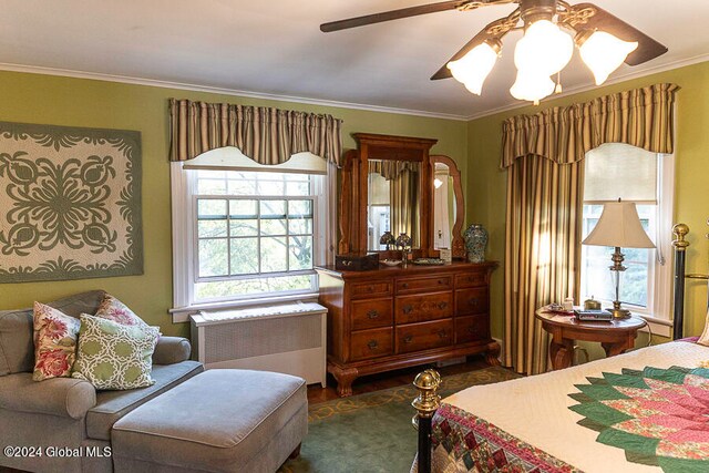 bedroom featuring ornamental molding, ceiling fan, and radiator heating unit