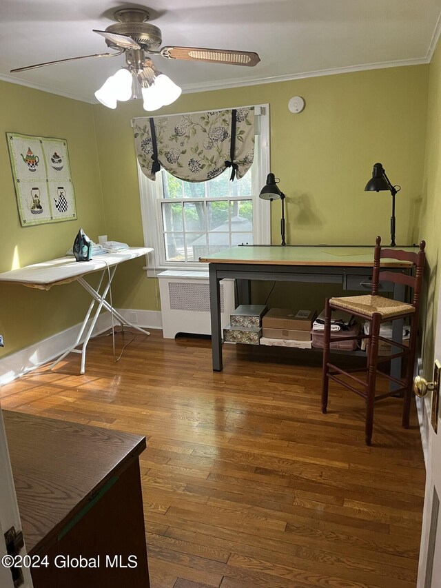 miscellaneous room featuring radiator heating unit, ornamental molding, ceiling fan, and hardwood / wood-style flooring