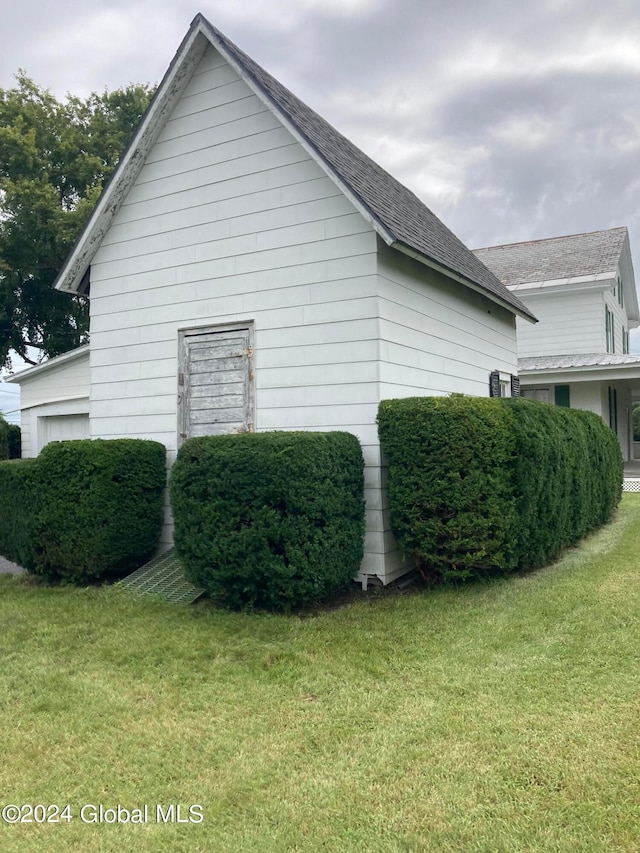 view of property exterior with a yard