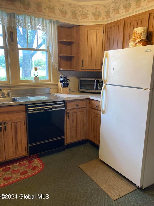 kitchen featuring sink, dishwasher, a healthy amount of sunlight, and white refrigerator