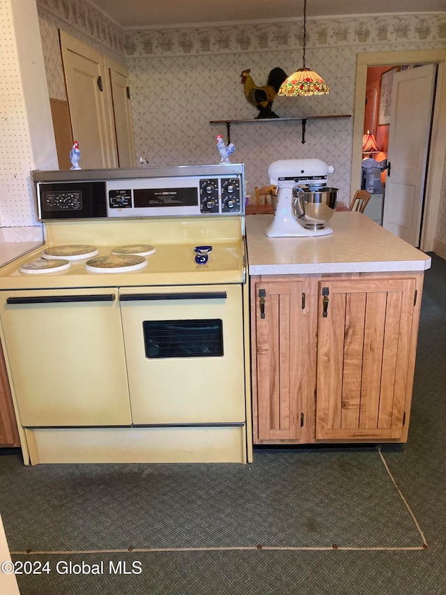 kitchen featuring electric range and pendant lighting