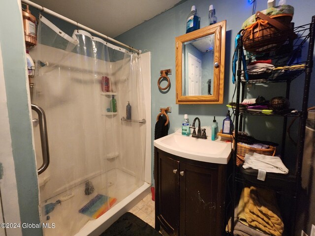 bathroom featuring tile patterned flooring, a shower with curtain, and vanity