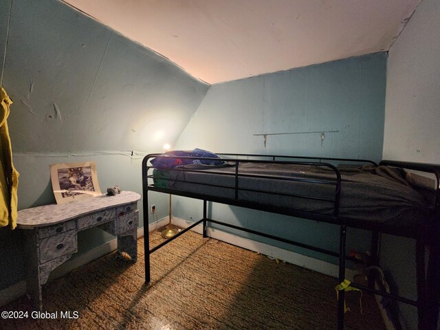 bedroom featuring carpet floors and vaulted ceiling