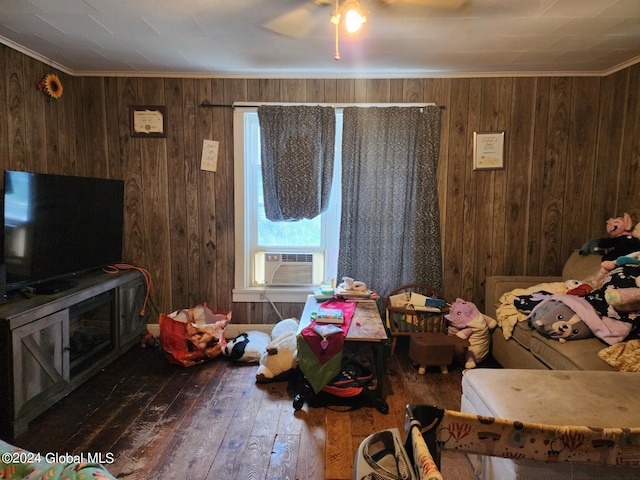 bedroom featuring ceiling fan, wooden walls, hardwood / wood-style floors, cooling unit, and crown molding