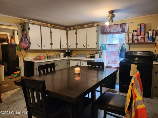 kitchen with white cabinetry and black / electric stove