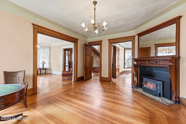 interior space featuring a notable chandelier, crown molding, and light wood-type flooring