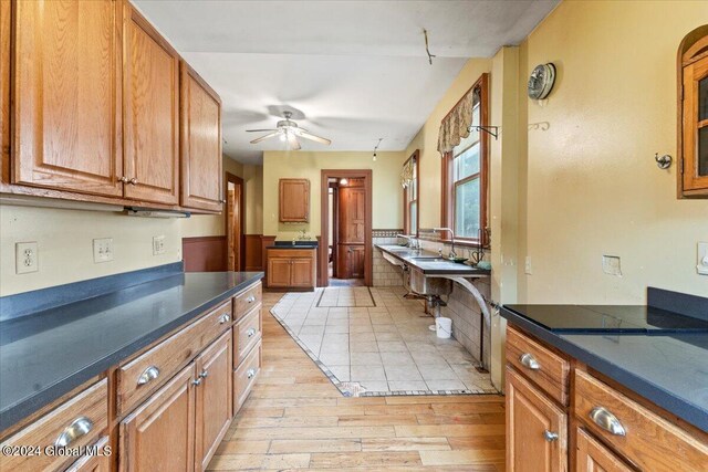 kitchen with ceiling fan and light hardwood / wood-style flooring