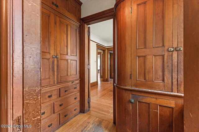 hall featuring light hardwood / wood-style flooring and ornamental molding