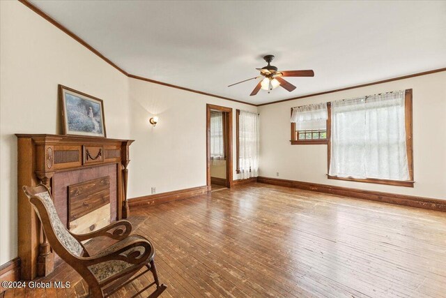 sitting room featuring ceiling fan, hardwood / wood-style flooring, and ornamental molding