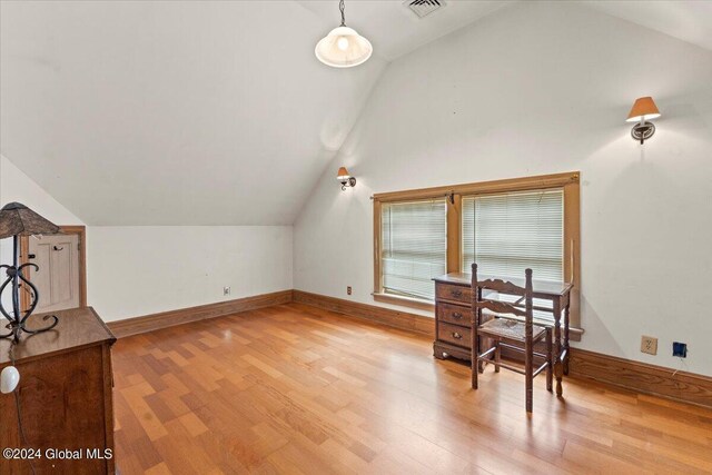 bonus room with lofted ceiling and light hardwood / wood-style floors