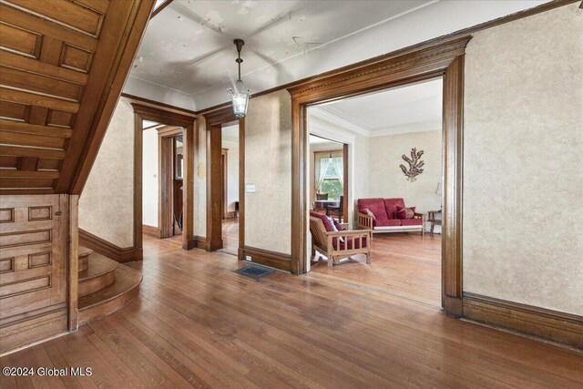 interior space featuring crown molding and hardwood / wood-style floors