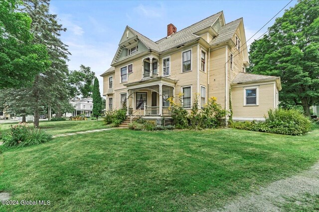 victorian home featuring a front yard